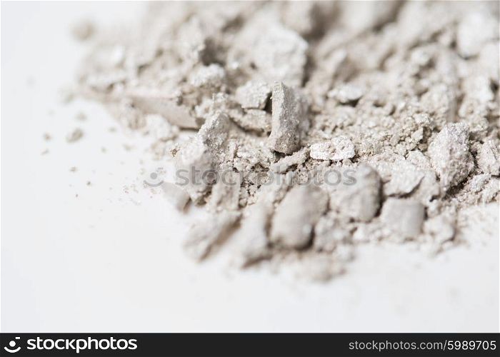 cosmetics, makeup and beauty concept - close up of loose eyeshadow or make-up powder pigment