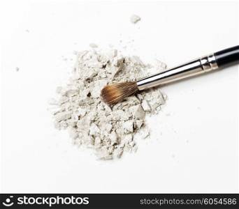 cosmetics, makeup and beauty concept - close up of makeup brush and eyeshadow