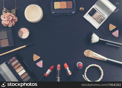 Cosmetics set for beautiful woman with pink rose necklace on black background. Brush on , lipstick , make up.