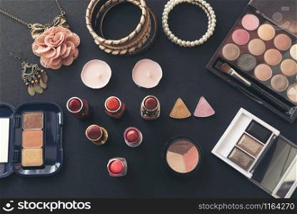 Cosmetics set for beautiful woman with red rose and pearl on pink background