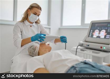 Cosmetologist applying laser to remove facial hair. Doctor in white lab coat working with woman client face at cosmetology cabinet. Cosmetologist applying laser to facial hair remove