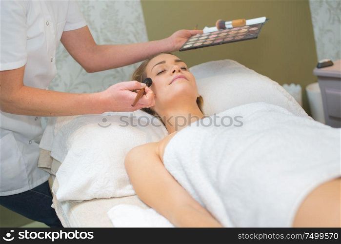 cosmetologist doing make up