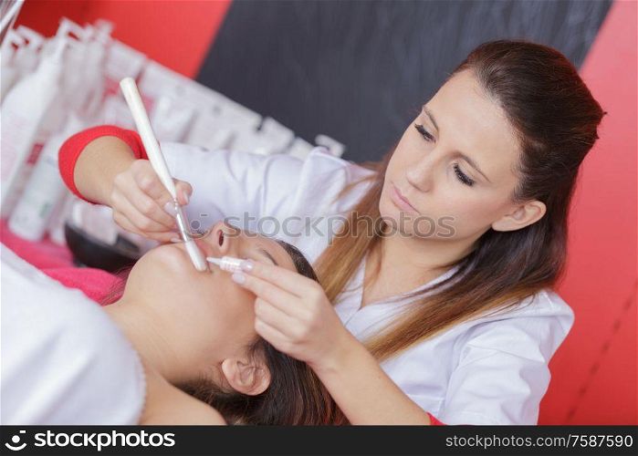 cosmetologist treating a client