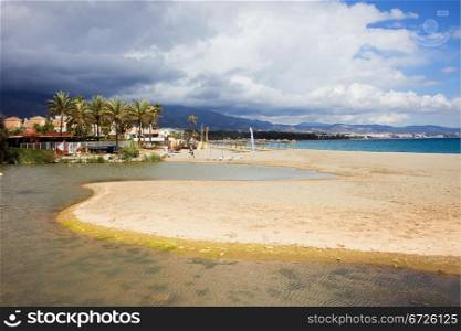 Costa del Sol in Spain, sandy beach located between Marbella and Puerto Banus, waters of Green River (Spanish: Rio Verde) and Mediterranean Sea.