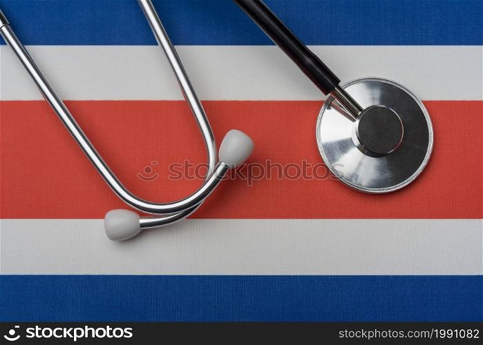 Costa Rica flag and stethoscope. The concept of medicine. Stethoscope on the flag as a background.. Costa Rica flag and stethoscope. The concept of medicine.