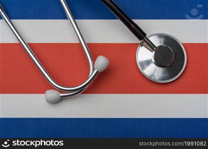Costa Rica flag and stethoscope. The concept of medicine. Stethoscope on the flag as a background.. Costa Rica flag and stethoscope. The concept of medicine.