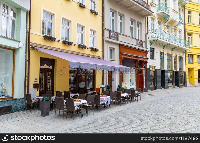 Cosy outdoor cafe on the cobblestone street, Karlovy Vary, Czech Republic, Europe. Old european town, famous place for travel and tourism. Outdoor cafe on cobblestone street, Karlovy Vary