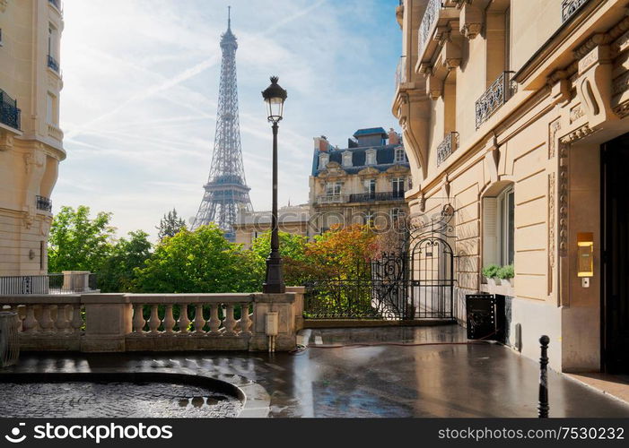 cosy Paris street with view on the famous Eiffel Tower on a cloudy summer day, Paris France. eiffel tour and Paris street