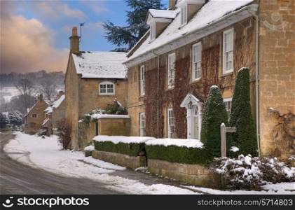 Cotswold house and cottages in snow, Broadway, Worcestershire, England.