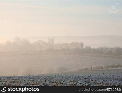 Cotswolds winter morning looking towards Chipping Campden through the mist, Gloucestershire, England.