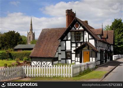 Cottage and church at Ombersley village, Worcestershire, England.