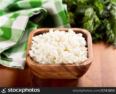 cottage cheese in a bowl on wooden table