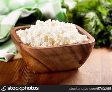 cottage cheese in a bowl on wooden table