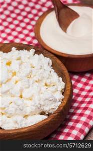 cottage cheese or curd in a wooden bowl