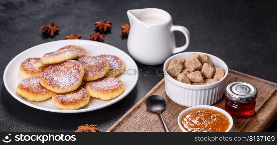 Cottage cheese pancakes on a black concrete background. Cottage cheese pancakes with oats, syrniki on a black rustic background