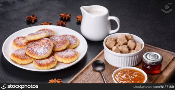 Cottage cheese pancakes on a black concrete background. Cottage cheese pancakes with oats, syrniki on a black rustic background