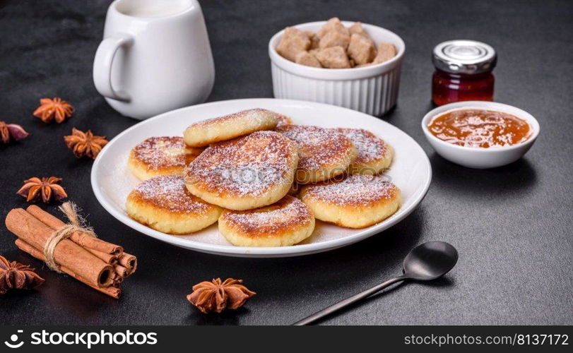 Cottage cheese pancakes on a black concrete background. Cottage cheese pancakes with oats, syrniki on a black rustic background