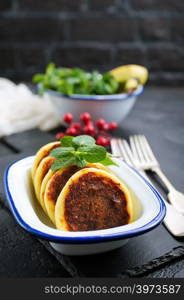 cottage cheese pancakes syrniki on plate, cheese pancakes and mint leaves