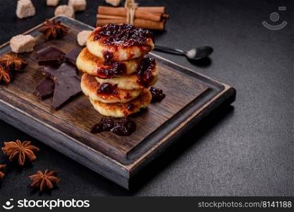 Cottage cheese pancakes, syrniki, ricotta fritters on a wooden cutting board. Homemade useful pastries. Cottage cheese pancakes, syrniki, ricotta fritters on a wooden cutting board