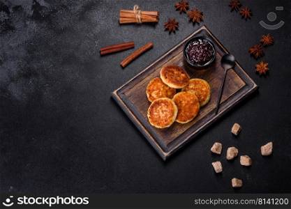 Cottage cheese pancakes, syrniki, ricotta fritters on a wooden cutting board. Homemade useful pastries. Cottage cheese pancakes, syrniki, ricotta fritters on a wooden cutting board