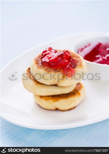 Cottage cheese pancakes with currant jam, selective focus