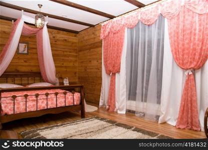 cottage interior: bed and window with curtain