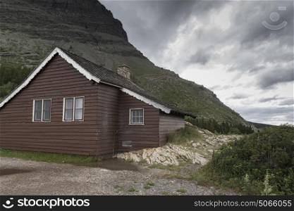 Cottage on hill against cloudy sky, Many Glacier, Glacier National Park, Glacier County, Montana, USA