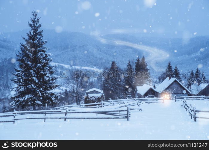 Cottage with smoke in winter fairy snowy mountain forest. Winter landscape. Cottage with smoke in winter fairy snowy mountain forest. Winter