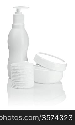 cotton pads bottle and cream isolated