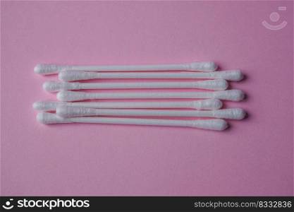 cotton swabs on the pink background, cosmetics and hygiene
