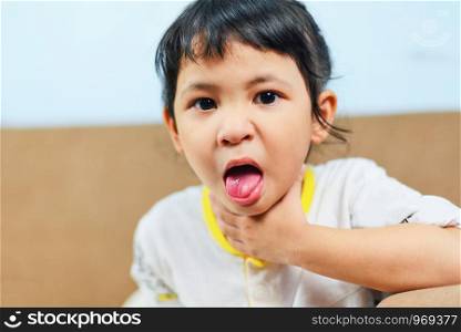 Coughing and Sore throat / Asian little girl sick fever cold , Child Stick out tongue
