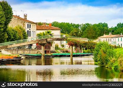 Coulon town in France. River view with boats. Deux Sevres, New Aquitaine region. Tourism place. Coulon village in France