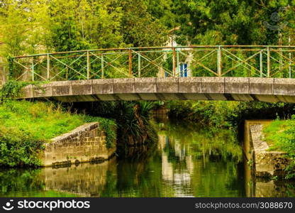 Coulon town in France. River view with old stone bridge. Deux Sevres, New Aquitaine region. Tourism place. River with bridge. Coulon town in France