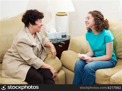 Counselor and teen girl have a friendly, positive conversation.