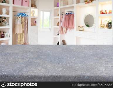 counter with copy space with white modern wardrobe with stylish female clothes in background. wardrobe with clothes