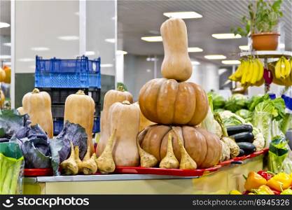 Counter with different fresh vegetable in marketplace