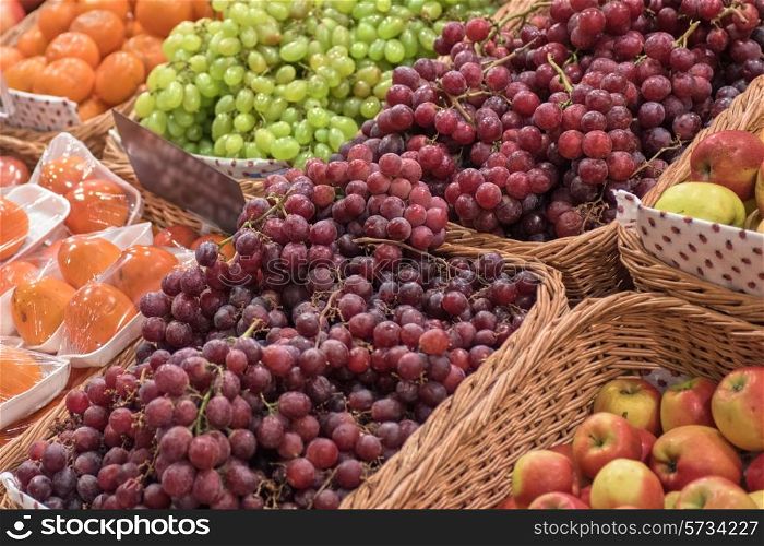 Counter with ripe grapes in supermarket