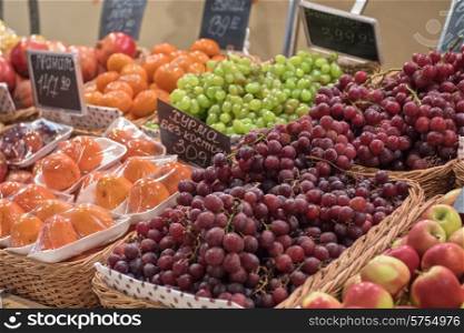 Counter with ripe grapes in supermarket . supermarket