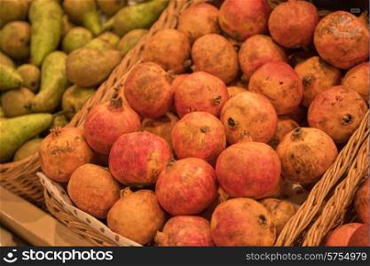 Counter with ripe pomegranates in supermarket . pomegranates