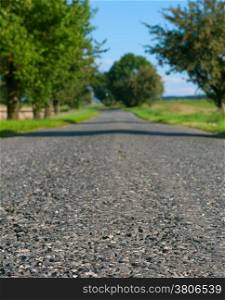 Country Asphalt Road - Shallow Depth of Filed. Focus on Front Part of Road.