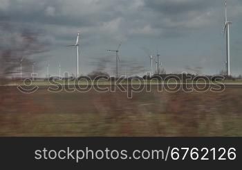 Country landscape view with windmills from moving train, Austria