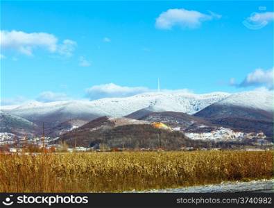 Country landscape with field and mountain with new-fallen snow ( Zakarpattia Oblast, Ukraine)
