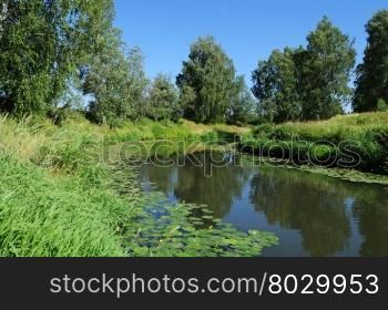 Country landscape with small slow river in summer time