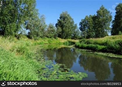Country landscape with small slow river in summer time