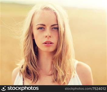 country, nature, summer holidays, vacation and people concept - young woman in white on cereal field. young woman in white on cereal field