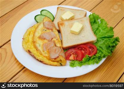 country omelette with bacon, salad and toasts