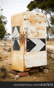 Country road signs plastered onto an old fridge