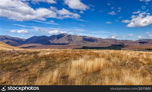 Countryside and distant mountains near Tekapo in New Zealand