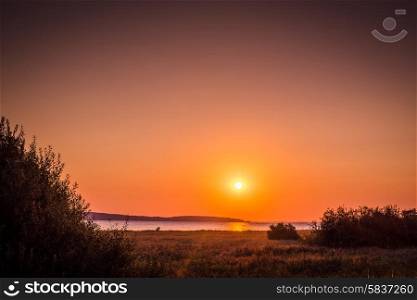 Countryside lake with a sunrise in the late summer