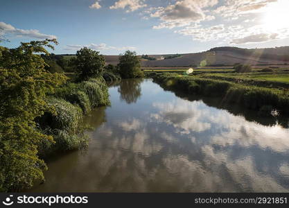 Countryside landscape blue sky reflected in calm river in Summer